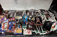 Image showing a spread of basketball trading cards with various players in dynamic poses, showcasing different card designs and vivid colors, displaying the quantity and condition of the cards.