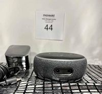 Amazon Alexa Echo Dot smart speaker and power adapter front view showing fabric covering and LED sensor.