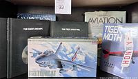 Overview photo showing F-14A Tomcat model kit in foreground with several aviation books in background including 'The Giant Airships', 'The First Aviators', 'History of Aviation', and 'Tiger Moth'.