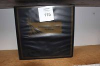 Closed black binder labeled 'Baseball Card Album'.