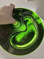 Close-up image showing the forest green glass bowl's inner compartments and glossy finish, highlighting the dual chambers and the smaller hole for toothpicks.