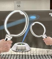 Original boxed Sharper Image Space Pong set showing the game projecting light beams between two paddle-shaped controllers, suitable for ages 8+