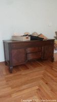 Front-side angle photo of vintage wooden buffet sideboard cabinet showing two drawers and two cabinet doors