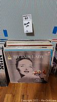 Photo showing a collection of vinyl soundtrack LP records with a prominent My Fair Lady album at the front.