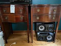 Front view of both side tables showing curved fronts and ring pulls