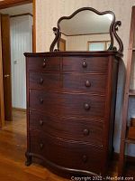 Full front view of six-drawer dresser with attached swivel mirror