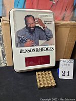 Front view of Benson & Hedges lighted clock with man holding trumpet and solid brass ashtray in front.