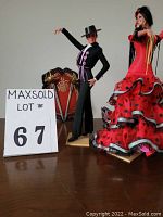 Photo showing male and female Marin Chiclana flamenco dancer dolls with fan in background.