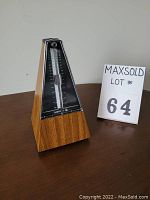 Front view of Samick SMM-98 wooden mechanical metronome showing tempo scale and pendulum.