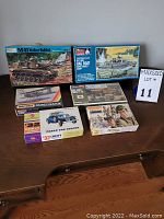 All six model kits arranged on a wooden surface showing box fronts and sizes
