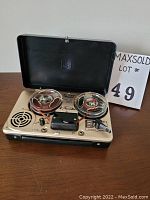 Honeytone portable reel-to-reel tape recorder with reels loaded, lid open showing controls, speaker grille, and reels.