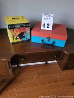 Photo of the closed Vagabond record player case next to the box of educational records.