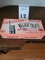 Original box of Lafayette HE 75 walkie talkie with orange graphics and text highlighting features and brand