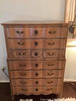 Front view of two-piece wooden dresser showing drawers and hardware