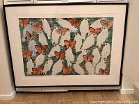 Full view of framed print leaning against wall