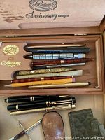Wooden Padron 1964 Anniversary Series box open showing pens and pencils