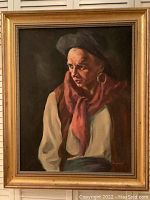 Full view of the framed oil on canvas portrait of a man with hat and hoop earring, signed 'Hayward'.