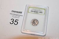 Top front view of encapsulated 1943 Lincoln steel penny with slab label visible, showing the coin and authentication.