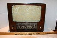 Front view of the vintage Rogers Majestic radio showing fabric speaker cover and tuning dial with two control knobs.