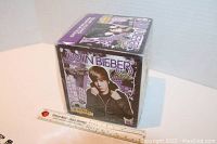 Full view of the sealed box from the front with ruler for size reference.