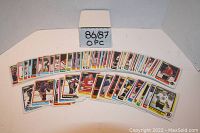 Photo showing 70 hockey cards fanned out in two rows and labeled in a cardboard box marked 86/87 OPC