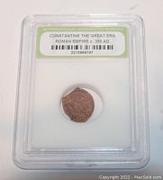 Front side of slabbed Roman coin featuring details of the coin and certification label.