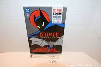 Photo of the sealed Batman vs Manbat DC Comics comic book showing front cover with Batman figure, cityscape, and issue information.