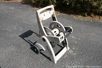 Full view of crank style mobile hose holder showing wheels, handle, and hose drum.