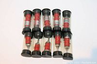 Lot of 10 sealed multi-pole rotary switches in clear plastic cylindrical tubes with black caps, showing red switch body and label.