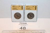 Front view of two slabbed Kennedy Half Dollar coins graded MS70 by SGS showing obverse side with Kennedy profile.