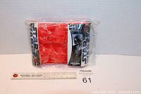 Front view of sealed Star Wars Darth Vader red silicone ice cube tray in original packaging with ruler for scale.