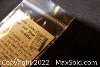 Silver bar in clear plastic bag with certificate showing Valcambi Suisse branding and purity of 1 gram .999 fine silver.