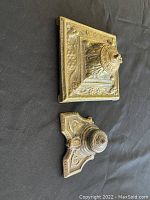 Side angle showing both ink wells placed on black fabric background for scale and detail view