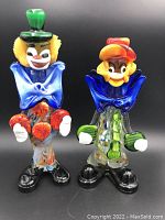 Front view of the two Murano clown glass figurines clearly showing color and facial detail.