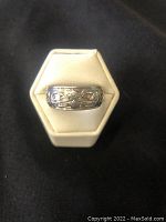 Front view of the silver ring showing central First Nations wolf motif.