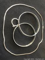 Photo showing 18 inch chain necklace, size 6.5 ring, and two 3 inch sterling silver stretch bracelets together.