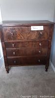Full view of antique wooden secretary chest with drop front.