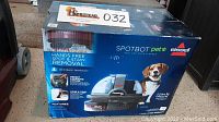 Box showing Bissell SpotBot Pet spot and stain cleaner with hands free removal and pet image