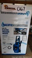Box showing Pacific Hydrostar electric pressure washer branding and key specifications including 1650 PSI maximum pressure, 1.2 gallons per minute flow, 13 amp motor, and included accessories like spray wand, hose, and soap sprayer.