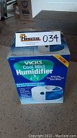 Box of Vicks Cool Mist Humidifier showing front and top with branding and product image.