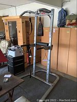 Wide view of the Bowflex workout machine showing its metal frame and attachments