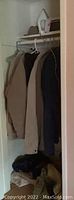 Mens XXL jackets and coats hanging in closet, including beige, dark blue, and brown colors
