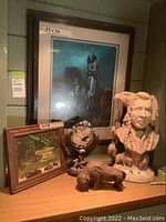 Overall lot showing ceramic bust, framed painting, wooden buffalo sculpture, eagle dream catcher figurine, and buffalo figurine.