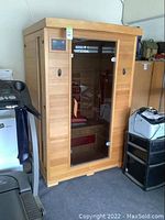 Front view of cedar sauna unit with tempered glass door
