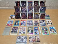 Overview photo showing a variety of sports cards including baseball, football, and basketball cards arranged on a flat surface