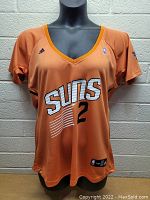 Front view of the orange women's Phoenix Suns Adidas jersey with number 2 and logo.