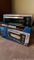 Black & Decker Home countertop convection oven shown on top of its original packaging box.
