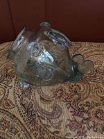 Side view of clear art glass fish sculpture showing body details and fins.