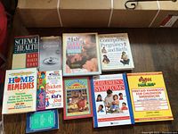 Photo showing 9 assorted health and children's books laid on floor.