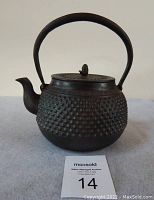 Front view of kettle with arched handle upright and lid attached